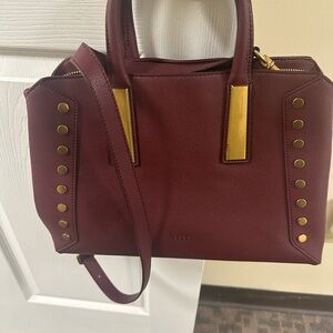 DKNY burgundy wine leather satchel bag with brass rivets and shoulder strap